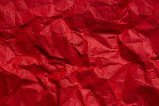 istock Close-up of red crumpled paper texture,wrinkled red paper texture,Rectangular crumpled sheet of red paper on a white isolated background 2190956828