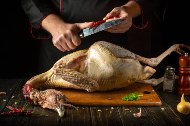 istock A master chef hands use a knife to slice red peppers before adding them to a large turkey to create a savory dish for a fine dining restaurant. National dish made from poultry 2190958333