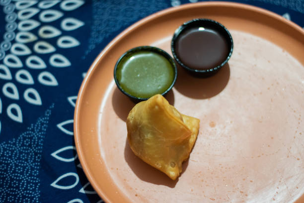 istock Delicious samosa with mint and tamarind chutney on a plate. 2190958415