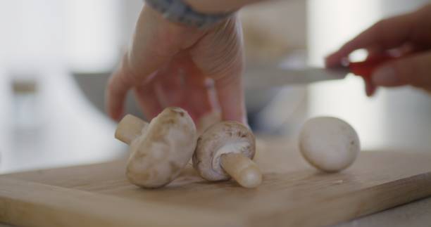 istock Slow Motion of Mushrooms Falling on Chopping Board 2190961586