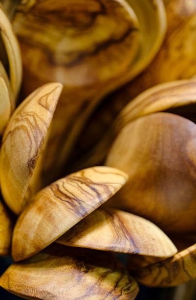 A large group of handmade wooden spoons, abstract woodwork background
