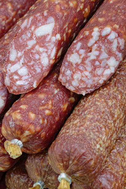 A large pile of smoked sausages, food background