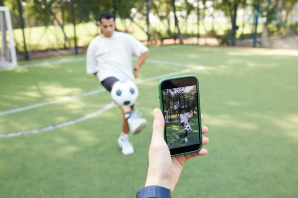 istock Using a smartphone, they video-record their soccer abilities for social media content. 2190967930