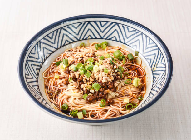 istock Sichuan Dan dan noodles topped with spring onion and nuts served in bowl isolated on white background side view of hong kong food 2190970603