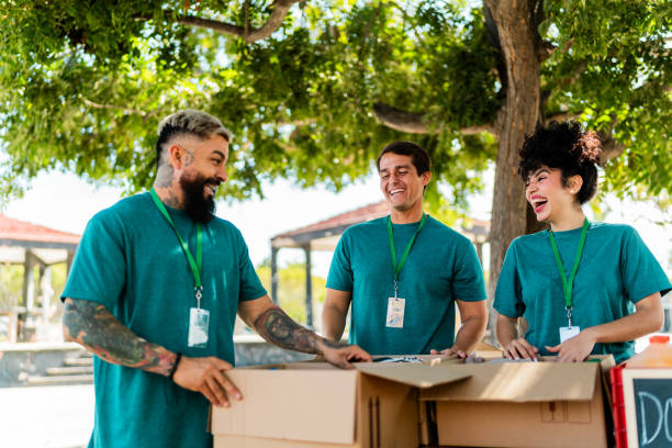 istock Volunteer organizing donation boxes and talking outdoors 2190973909