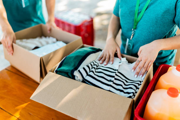Close-up of volunteer organizing donation boxes
