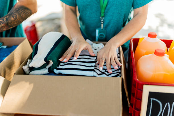 istock Close-up of volunteer organizing donation boxes 2190974101