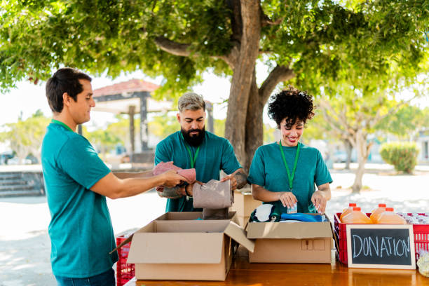 istock Volunteers talking and organizing donation boxes outdoors 2190974102
