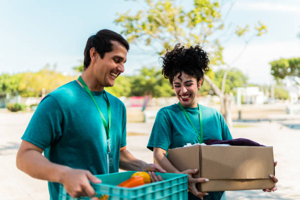 Volunteers talking and walking with donation boxes outdoors