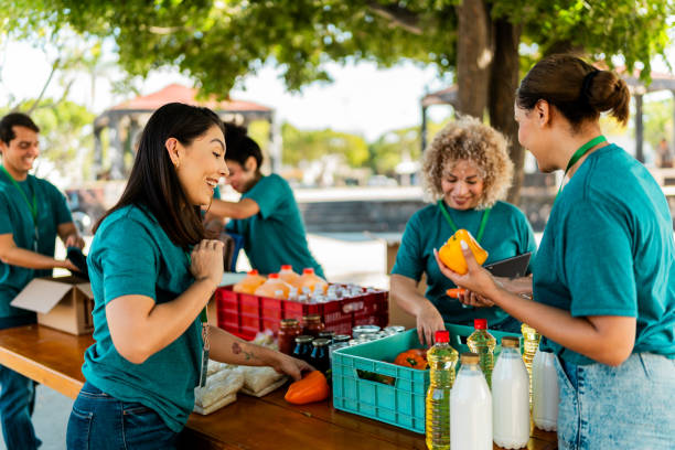 istock Volunteers talking and organizing donation boxes outdoors 2190974117