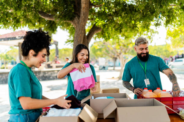 istock Volunteers talking and organizing donation boxes outdoors 2190974168
