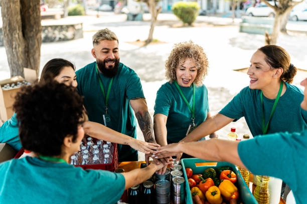 istock Volunteer organizing donation boxes and talking outdoors 2190974228