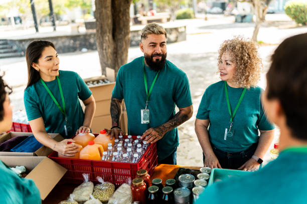 istock Volunteers talking and organizing donation boxes outdoors 2190974233