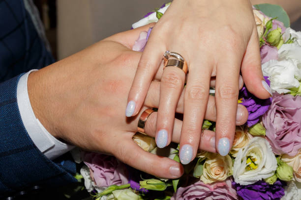 istock newlyweds with wedding rings hold a wedding bouquet 2190975678