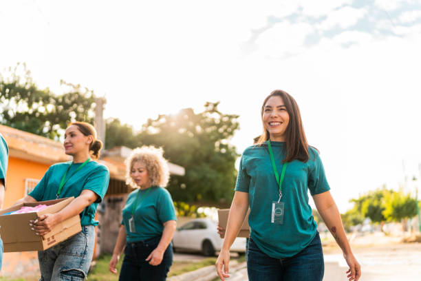 istock Volunteers walking with donation boxes outdoors 2190975757