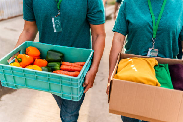 istock Volunteers walking with donation boxes outdoors 2190975774