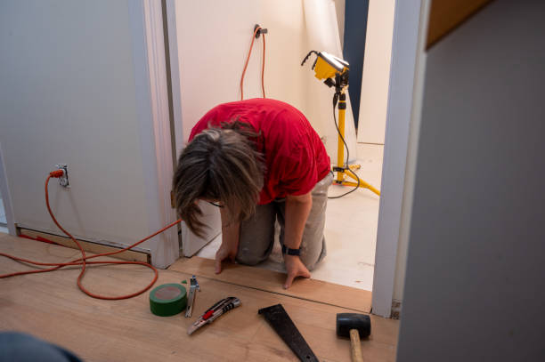 istock Mature woman installing Floating wooden floors 2190976222