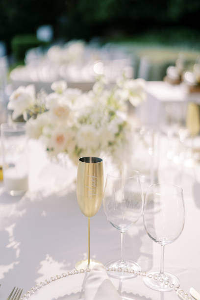 istock Bronze goblet stands next to glass glasses on a set table 2190976229