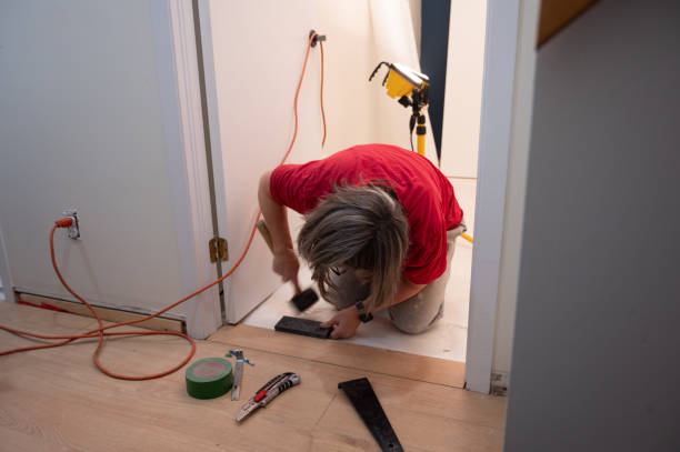 istock Mature woman installing Floating wooden floors 2190976233