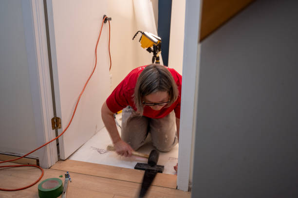 istock Mature woman installing Floating wooden floors 2190976337