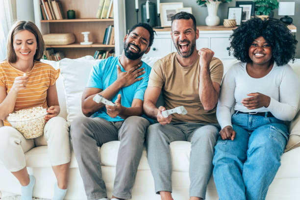 istock Group of friends having fun playing video games at home. 2190980372