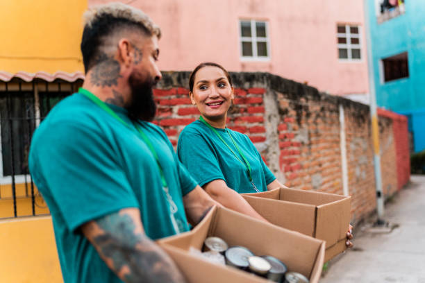 istock Volunteers talking and carrying donation boxes outdoors 2190984251