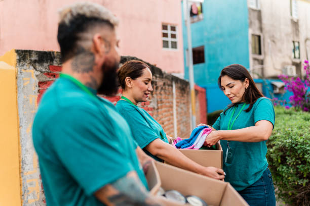 istock Volunteers talking and carrying donation boxes outdoors 2190984259