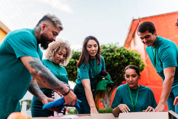 istock Volunteers talking and organizing donation boxes outdoors 2190984260