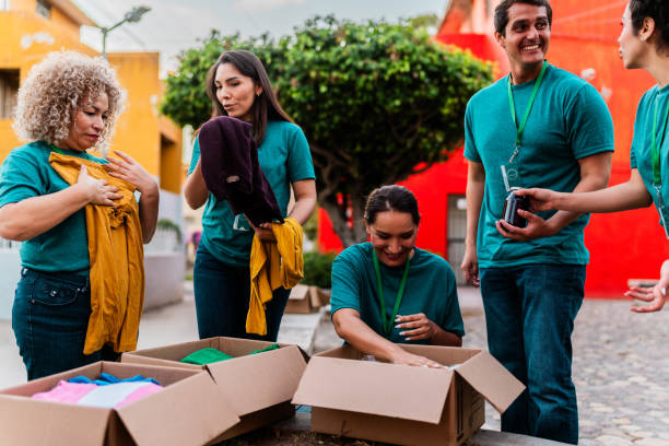 istock Volunteers talking and organizing donation boxes outdoors 2190984261