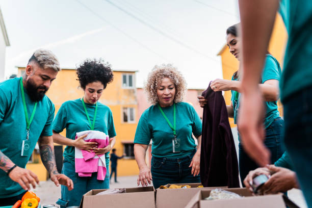 istock Volunteers talking and organizing donation boxes outdoors 2190984279