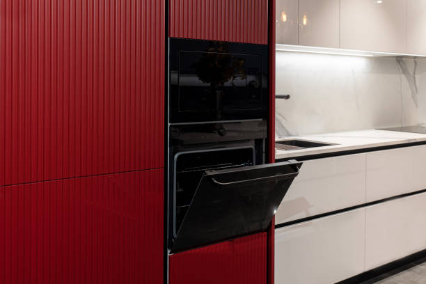 istock Modern black built-in oven and microwave in a red kitchen with a open door 2190987924