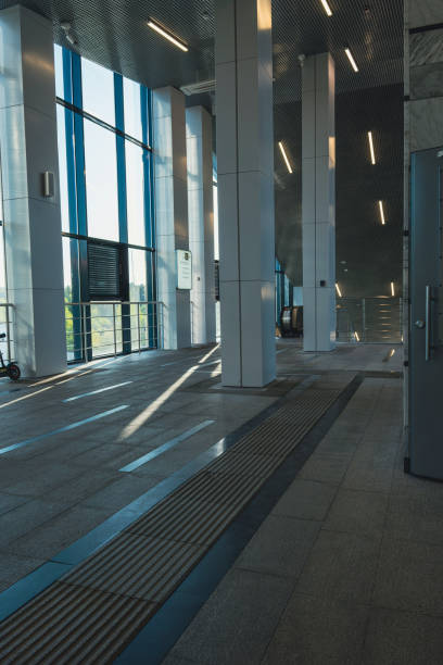 istock Spacious modern train station interior with sunlight and glass walls 2190991017