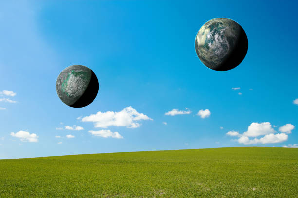 Captivating scene of two celestial bodies hovering over a green meadow with a blue sky, providing a sense of wonder and featuring ample negative space and room for text, perfect for creative designs.