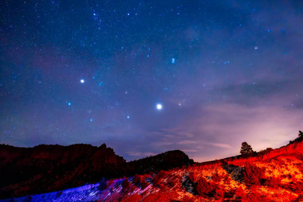 Starry Night Sky in Scenic Red Rock Canyon - Night astrophotogrphy scenic view with sky full of stars plus the planets Jupiter and Uranus.