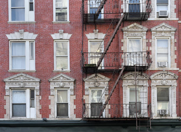 New York City, old apartment building with external fire ladder and ornamental carvings around windows