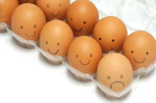 brown eggs with smile and sad face drawing