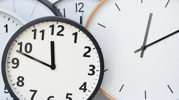 istock a collection of overlapping analog clocks, each with a clean and minimalistic design. The clocks have white faces with black hour and minute markings, and black or wooden frames. Let me know if you'd like assistance with this image! 2191013695