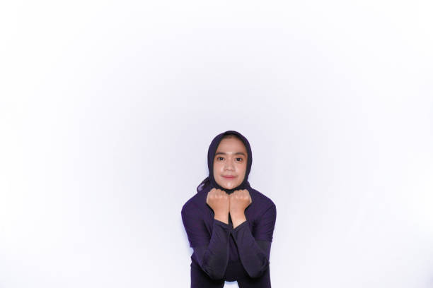 Gymnastic movements demonstrated by Asian women wearing hijabs in black clothes
