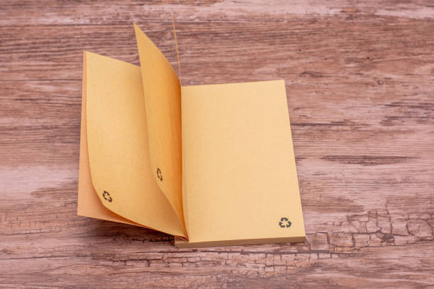 istock Brown Eco-Friendly Recycled Notebook with Recycling Logo. Minimalist brown notebook made entirely from recycled materials, featuring an embossed recycling logo on it. 2191019312