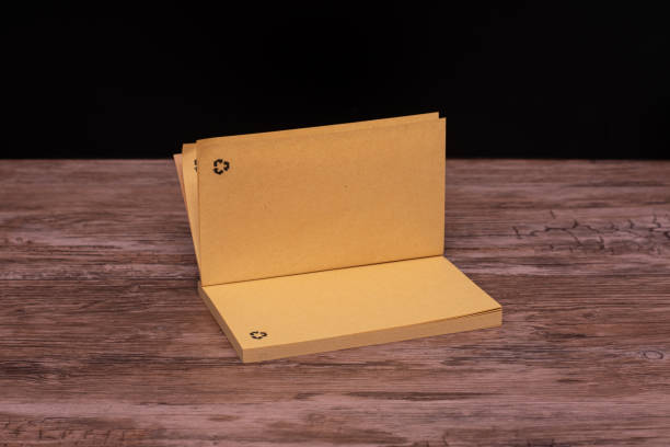 istock Brown Eco-Friendly Recycled Notebook with Recycling Logo. Minimalist brown notebook made entirely from recycled materials, featuring an embossed recycling logo on it. 2191019320