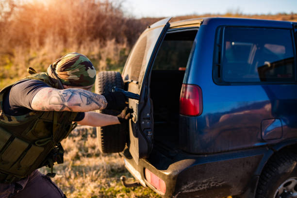 istock Tactical Officer Investigating SUV Outdoors in Rural Setting 2191023590