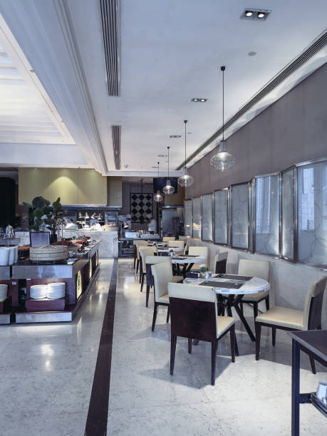 istock A modern and elegant restaurant interior with neatly arranged dining tables and chairs, featuring marble tabletops and soft lighting. 2191024528