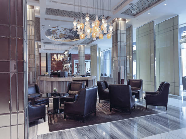istock A luxurious hotel lounge area featuring elegant leather armchairs, a central round table, and a sophisticated lighting design with ornate pendant chandeliers. 2191024627
