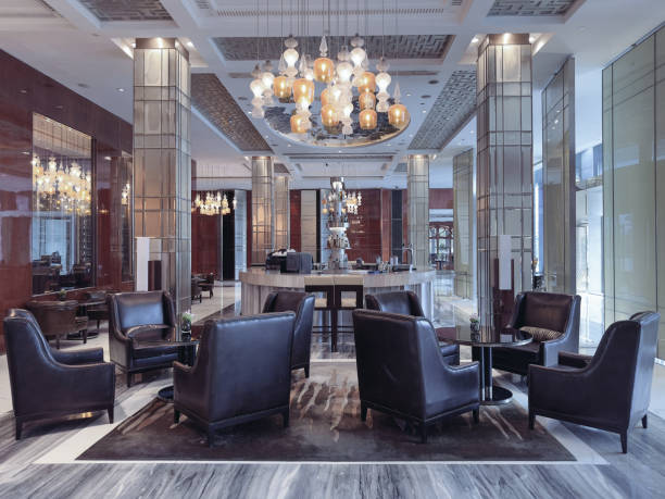 istock A luxurious hotel lounge area featuring elegant leather armchairs, a central round table, and a sophisticated lighting design with ornate pendant chandeliers. 2191024667