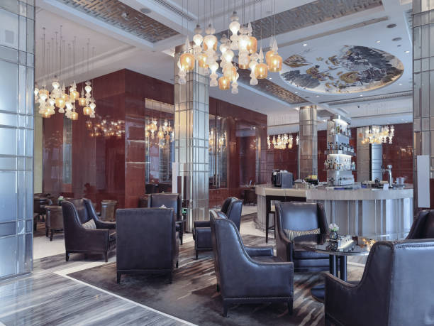 istock A luxurious hotel lounge area featuring elegant leather armchairs, a central round table, and a sophisticated lighting design with ornate pendant chandeliers. 2191024689