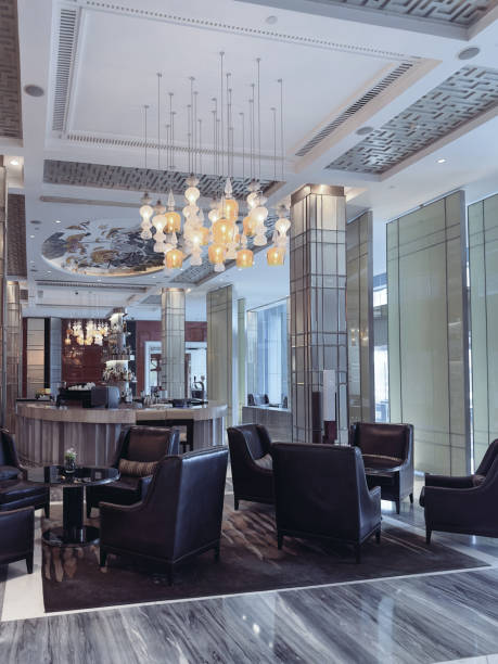 istock A luxurious hotel lounge area featuring elegant leather armchairs, a central round table, and a sophisticated lighting design with ornate pendant chandeliers. 2191024691