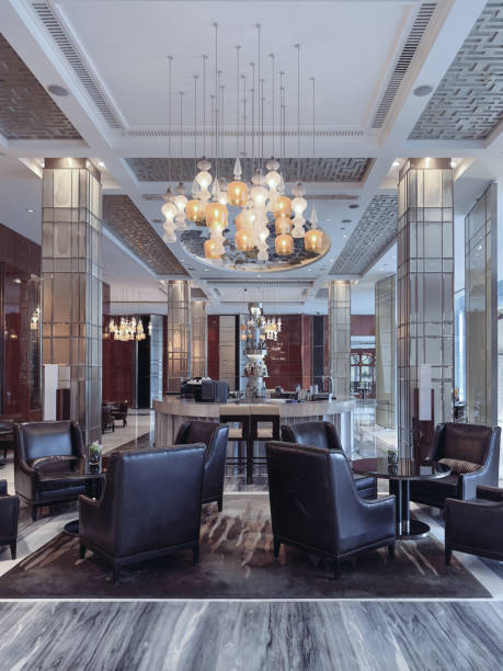istock A luxurious hotel lounge area featuring elegant leather armchairs, a central round table, and a sophisticated lighting design with ornate pendant chandeliers. 2191024706
