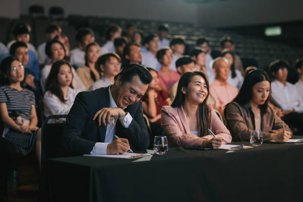 istock satisfied happy Asian panel judges giving score to stage performance competition in front of audience 2191026740