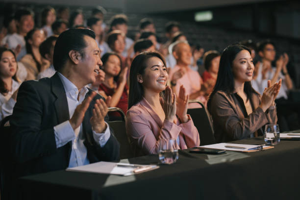 istock Asian panel judge applauding to stage performance competition in front of audience 2191026750