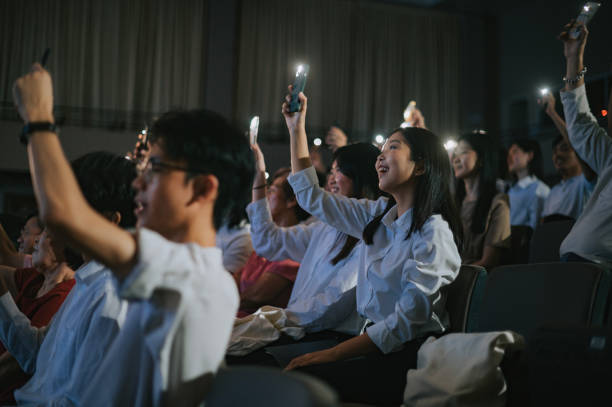 istock Asian young Crowd waving Smartphone Flash Lights singing along At Concert 2191026767